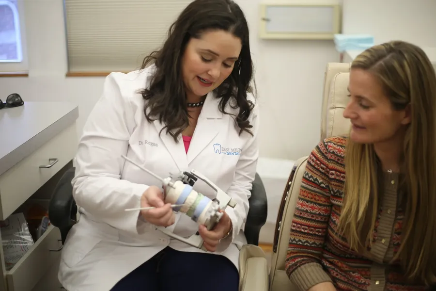 Dr. Regan explaining treatment to a patient